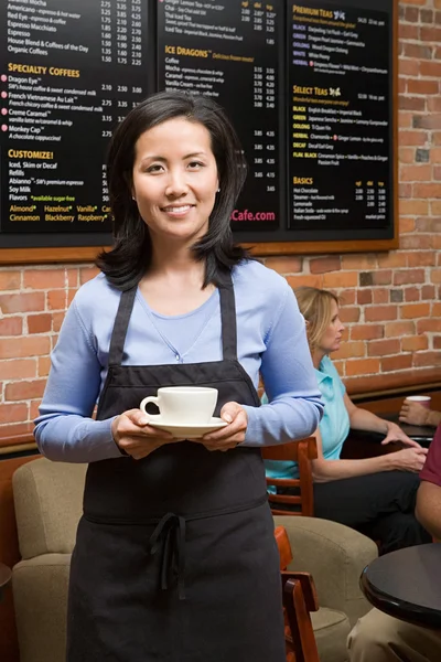 Waiter holding coffee cup — Stock Photo, Image