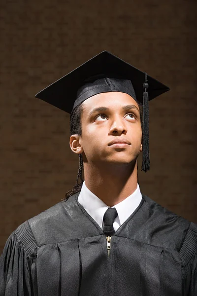 Male graduate looking up — Stock Photo, Image