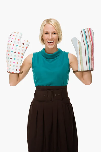 Woman wearing oven gloves