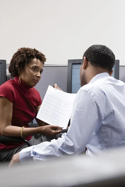 Woman showing form to colleague — Stock Photo, Image