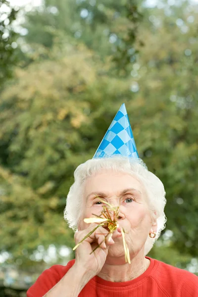 Mulher sênior em uma festa de aniversário — Fotografia de Stock