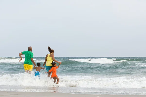 Familie springen in de zee — Stockfoto