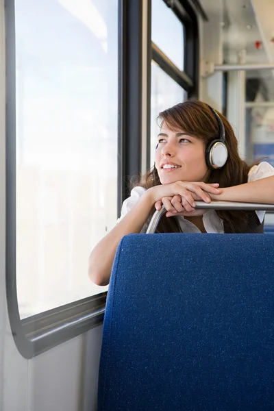 Woman listening to music in train — Stock Photo, Image