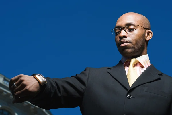 Businessman looking at his watch — Stock Photo, Image