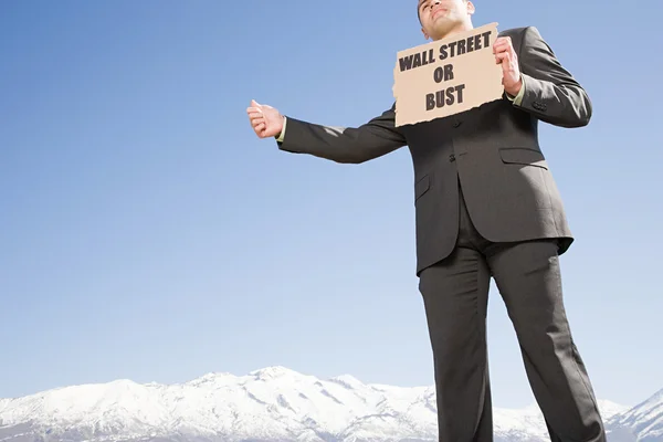 Businessman hitching a ride — Stock Photo, Image