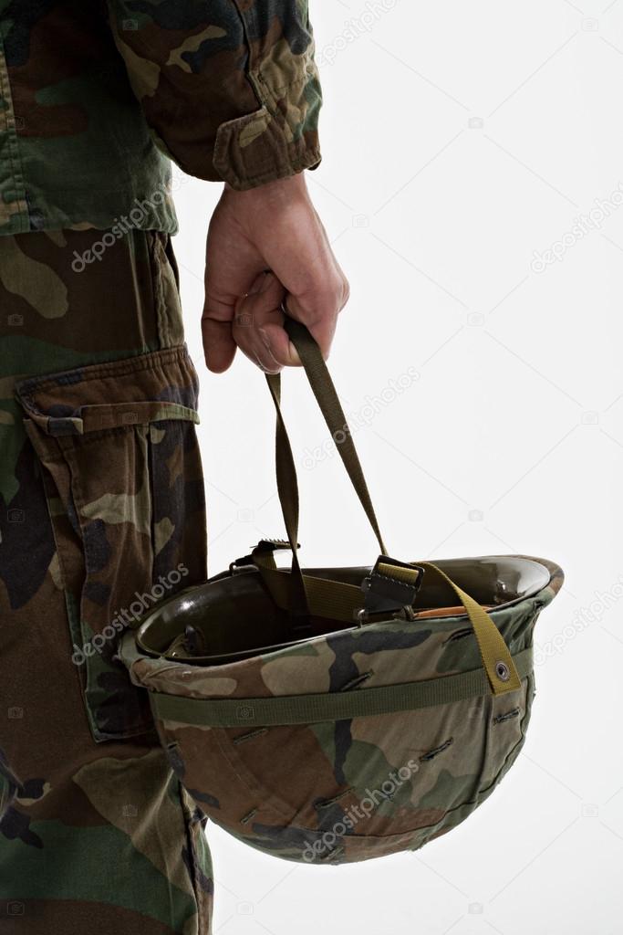 soldier holding helmet