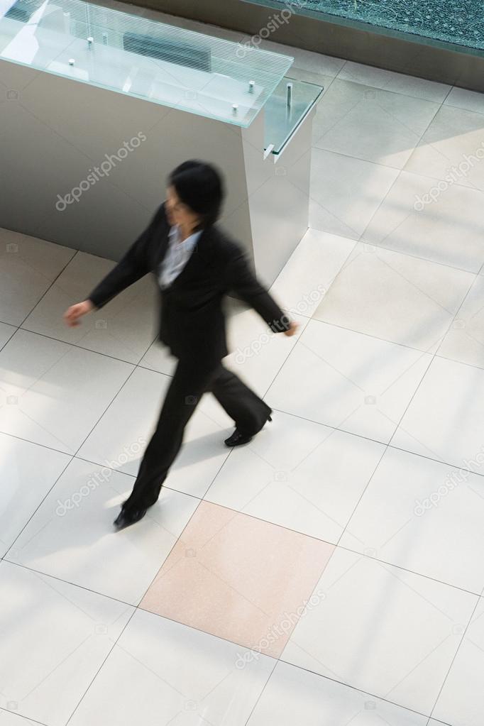 Blurred businesswoman walking in office