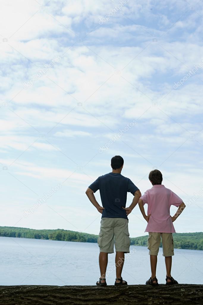 Father and son looking at lake