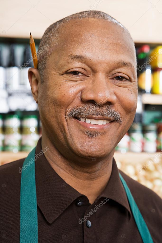 Portrait of a greengrocer smiling