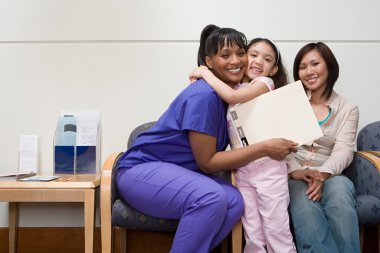 Girl hugging nurse in hospital clipart