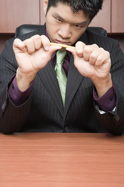 Businessman breaking pencil — Stock Photo, Image