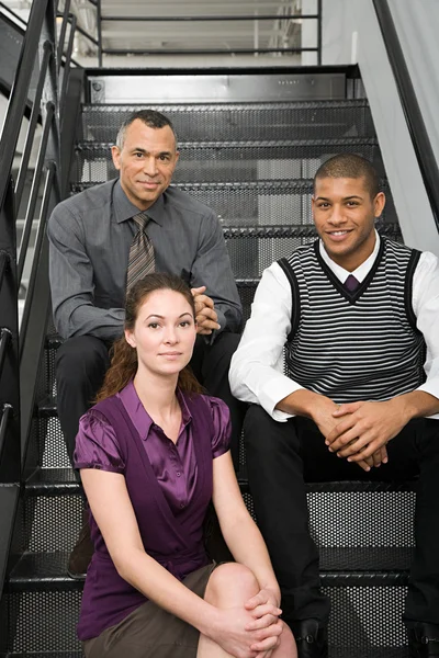 Colleagues sitting on stairs — Stock Photo, Image