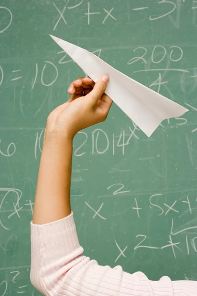 Student about to throw a paper aeroplane — Stock Photo, Image