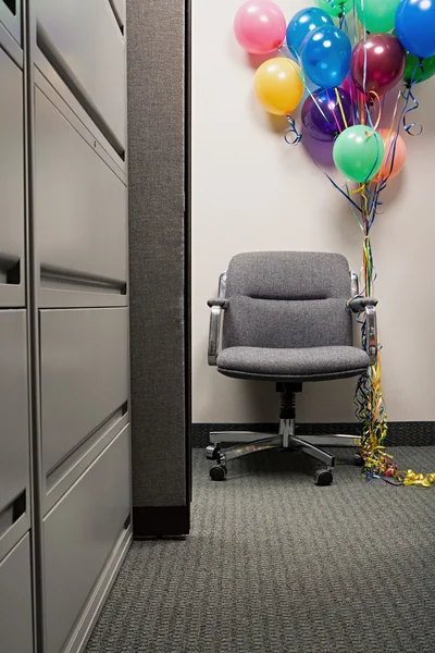 Bunch of balloons tied to office chair — Stock Photo, Image