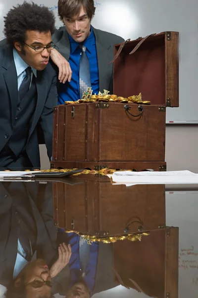 Colleagues looking at a treasure chest — Stock Photo, Image