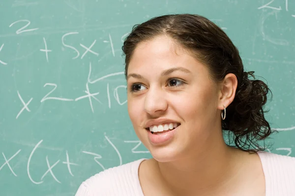 Female student in front of blackboard — Stock Photo, Image