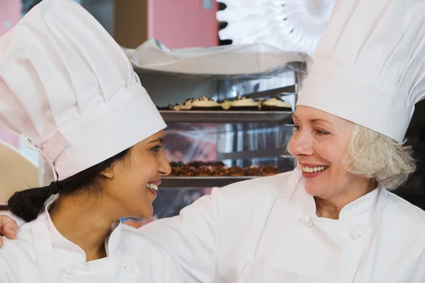 Bakers smiling each other — Stock Photo, Image