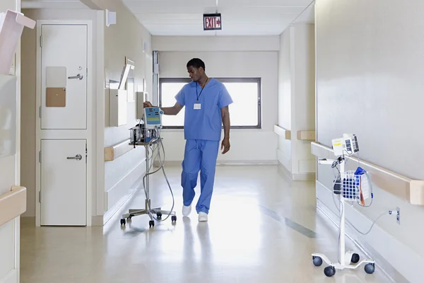 Больничный рабочий с капельницей внутривенно — стоковое фото