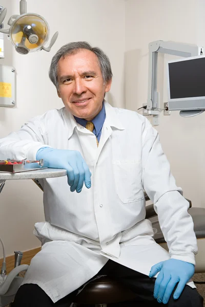 Dentist sitting in dental cabinet — Stock Photo, Image