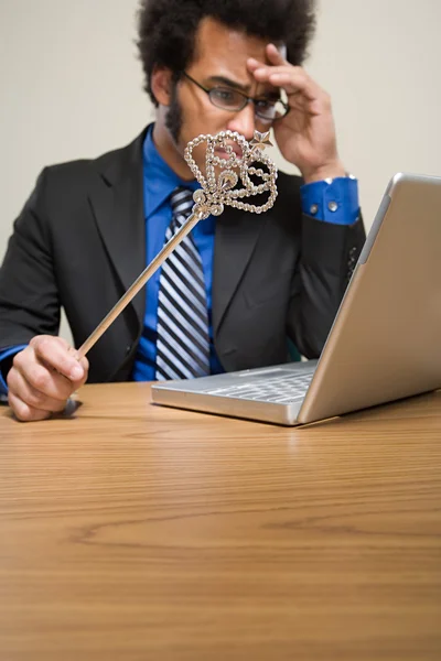 Businessman holding wand — Stock Photo, Image