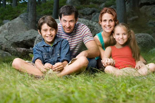 Familie zittend op het gras — Stockfoto