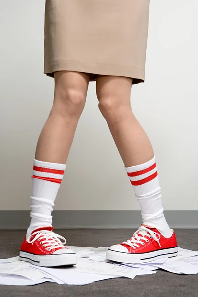 Female office worker wearing baseball boots — Stock Photo, Image