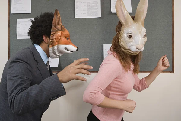 Office workers fooling around in masks — Stock Photo, Image