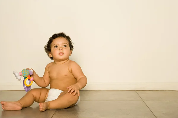 Baby holding rattle — Stock Photo, Image