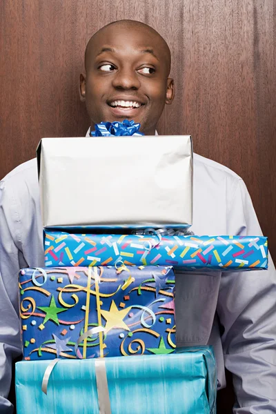 Businessman carrying presents — Stock Photo, Image