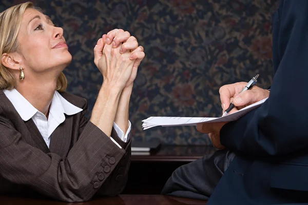 Businesswoman begging in office — Stock Photo, Image