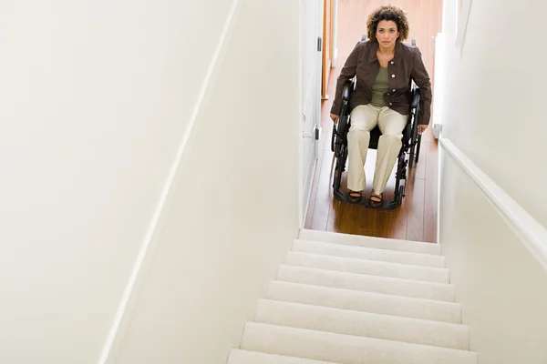 Disabled woman trapped at bottom of stairs — Stock Photo, Image