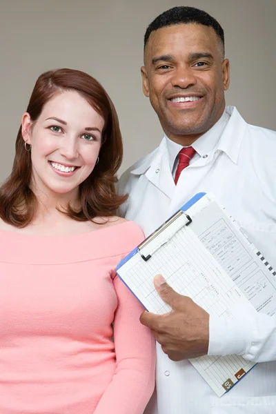 Dentist with patient smiling — Stock Photo, Image