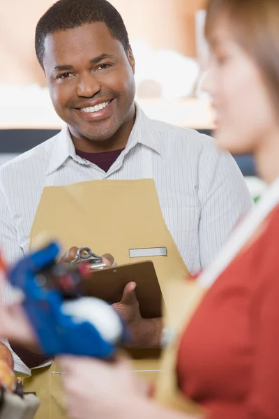 Woman and man smiling in supermarket Royalty Free Stock Photos