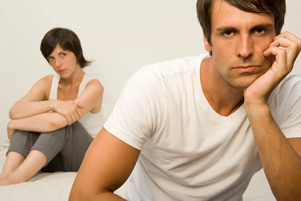 Couple arguing while sitting in bed Royalty Free Stock Images