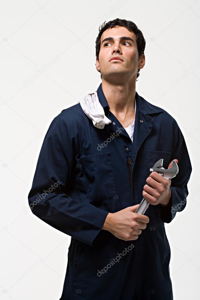 caucasian mechanic with tool