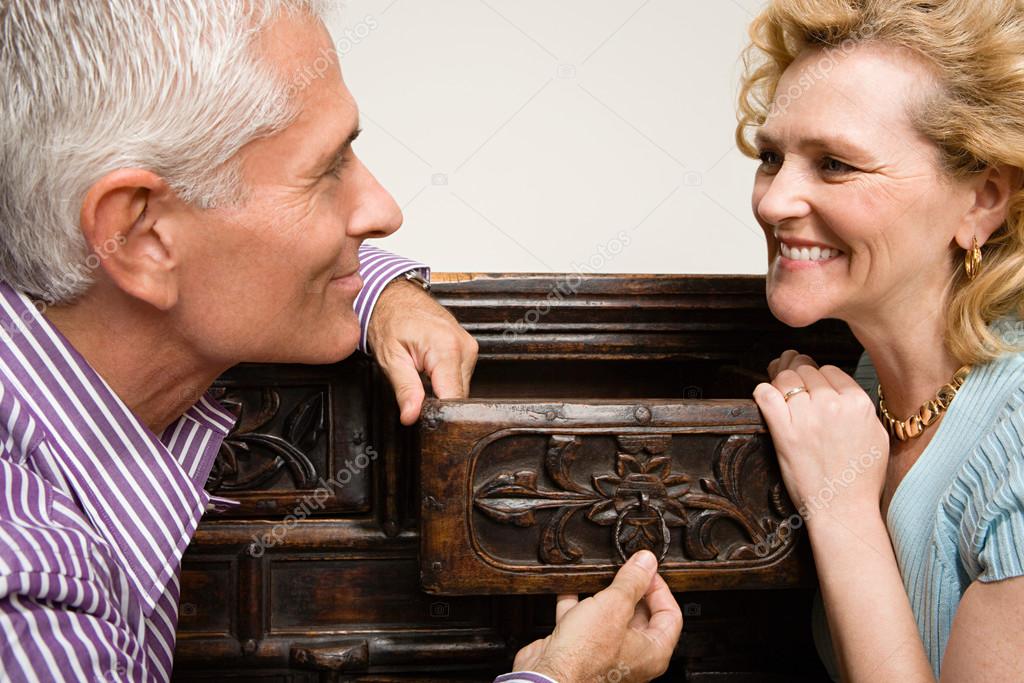 Couple looking at chest of drawers