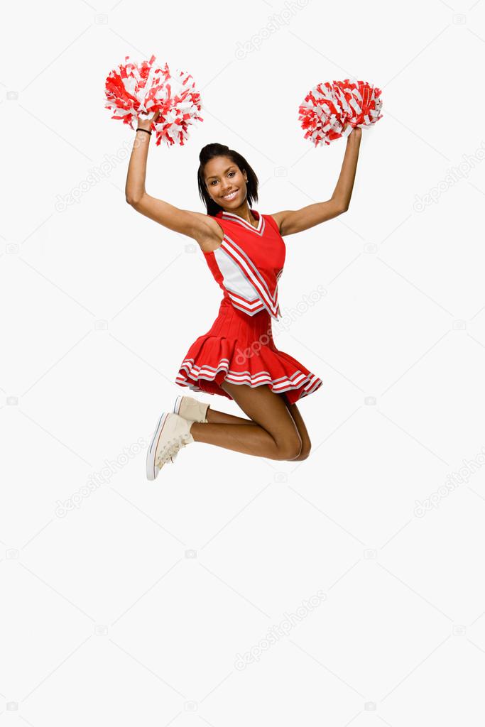 Cheerleader jumping and smiling