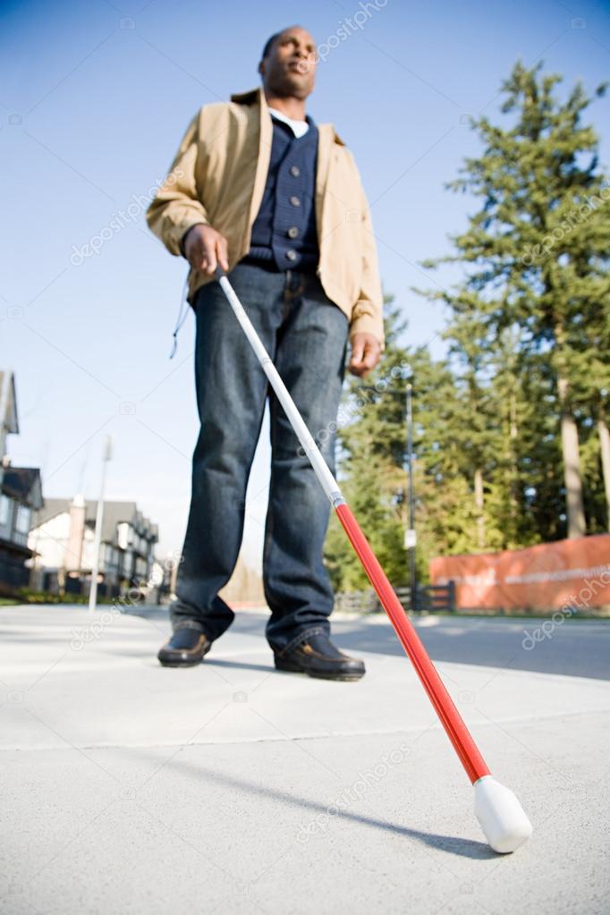 Blind man using a walking stick