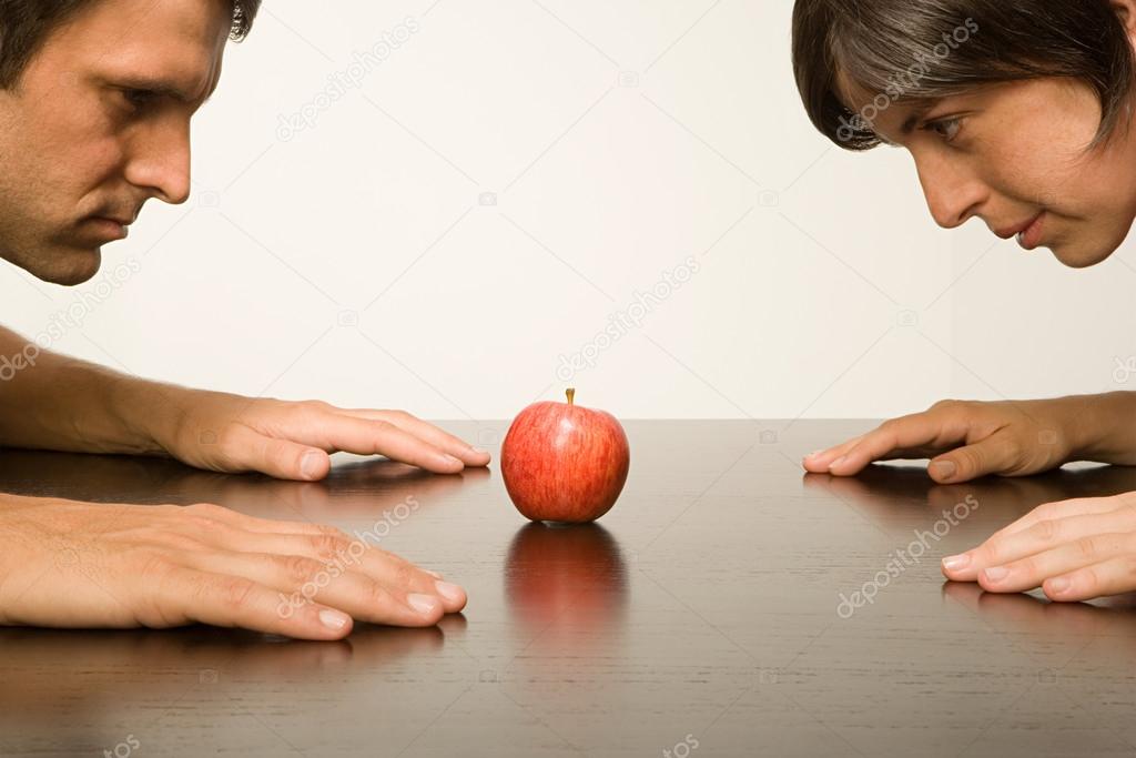 Couple staring at apple