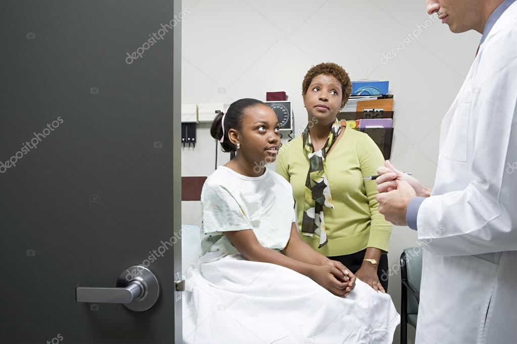 Girl and mother listening to doctor