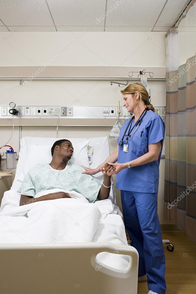 Doctor consoling patient in hospital