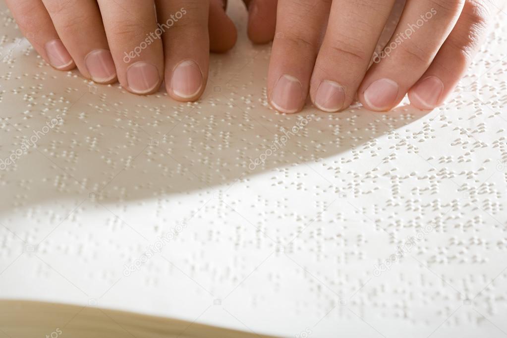 A woman reading braille