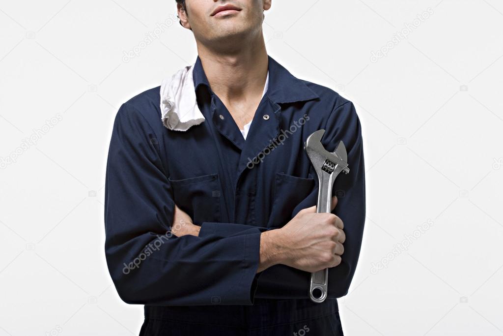 Portrait of a caucasian mechanic with tool