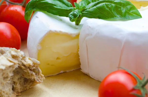 Queijo francês fedorento e tomates cereja vermelhos. Fechar. — Fotografia de Stock