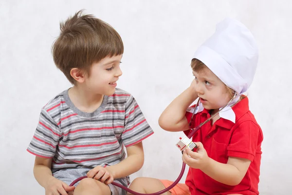 Two brothers play in doctor and patient Stock Photo