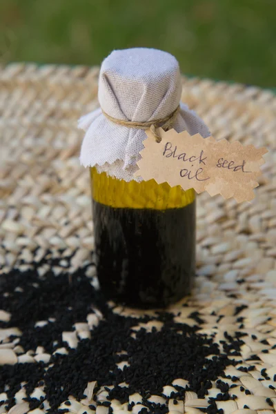 A bottle of black seed oil — Stock Photo, Image