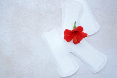 Daily panty liners on a white wooden surface clipart