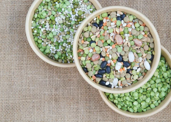 An assortment of legumes and cereals on a sackcloth — Stock Photo, Image