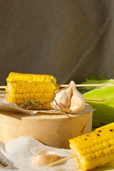 Grilled corn on a wooden surface — Stock Photo, Image