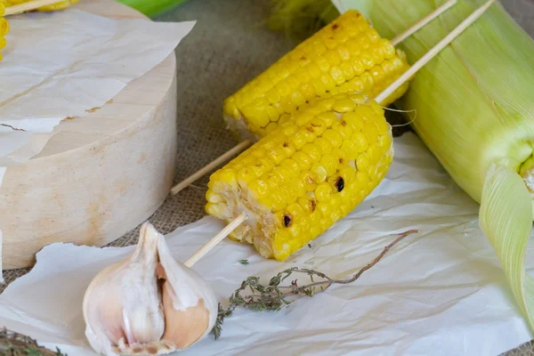 Grilled corn on a wooden surface — Stock Photo, Image